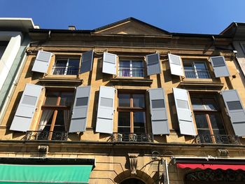 Low angle view of building against sky on sunny day