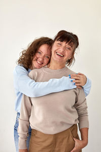 Portrait of a smiling young woman against white background
