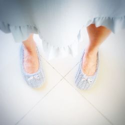 Low section of woman standing on tiled floor