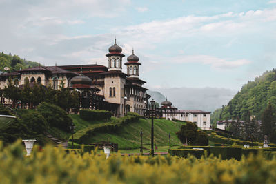 Buildings in town against sky