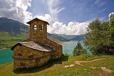 Built structure on landscape against sky