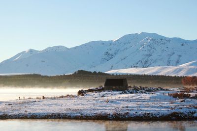 Scenic view of snowcapped mountains against clear sky