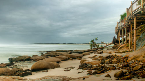 Rocks on beach against sky