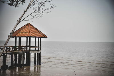 Lifeguard hut on beach against clear sky