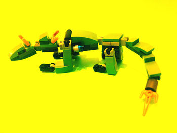 High angle view of toys against yellow background