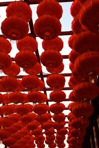 Low angle view of lanterns hanging against sky