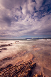 View of calm sea against clouds