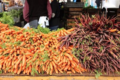 Stack of various vegetables at market stall for sale