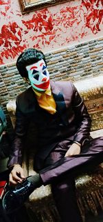 Midsection of man sitting on mask