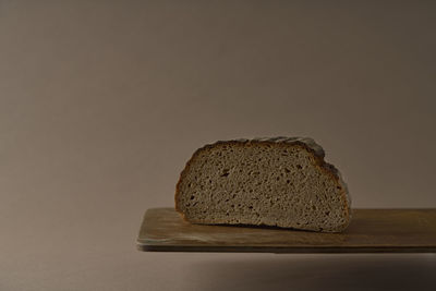 Close-up of bread on table against black background