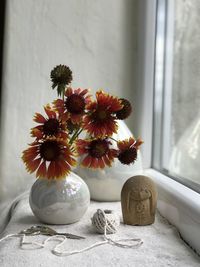 Close-up of flower vase on table at home