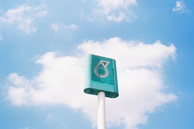 Low angle view of road sign against blue sky