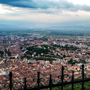 Cityscape against cloudy sky