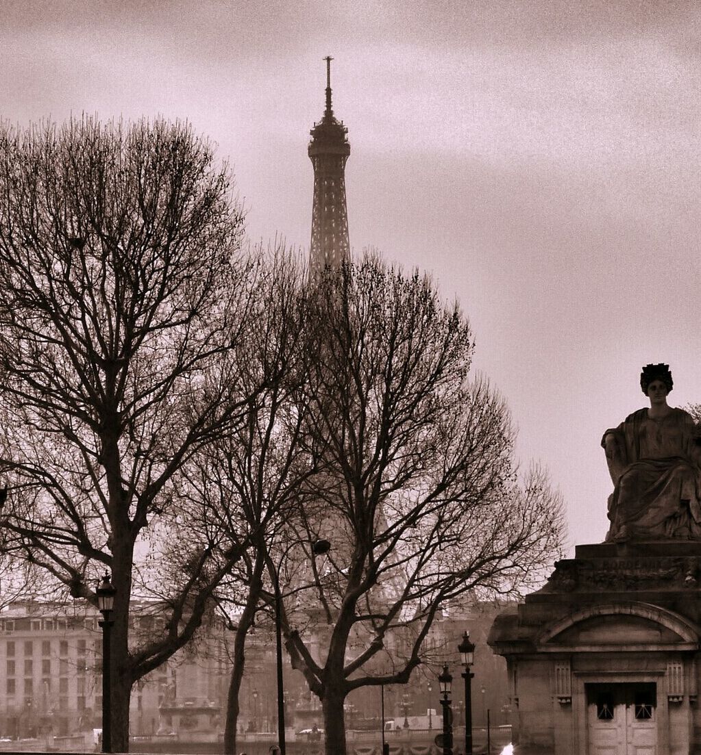 bare tree, tree, building exterior, architecture, built structure, sky, tower, branch, travel destinations, famous place, low angle view, tourism, city, tall - high, international landmark, travel, statue, capital cities, history, religion