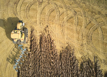 Drone aerial shots of a tractor ploughing a field at stone creek, sunk island, east yorkshire, uk.
