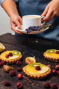 Midsection of person having breakfast on table