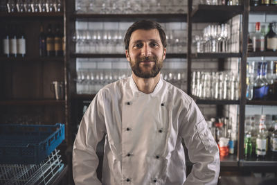 Portrait of smiling chef in commercial kitchen