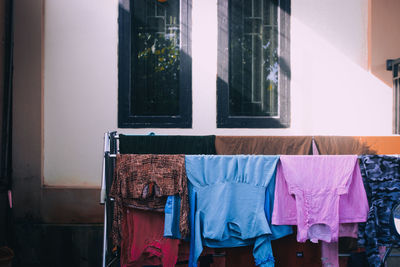 Clothes drying on window of building