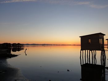 Scenic view of lake against sky during sunset