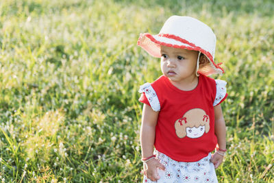 Portrait of cute girl standing against plants