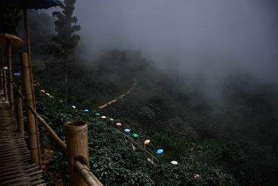Footbridge on mountain during foggy weather