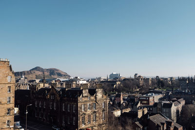 High angle view of buildings against clear blue sky