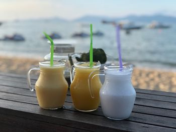 Close-up of drinks in glass jars on table