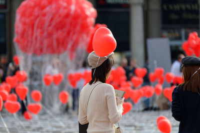 Rear view of women with red balloons