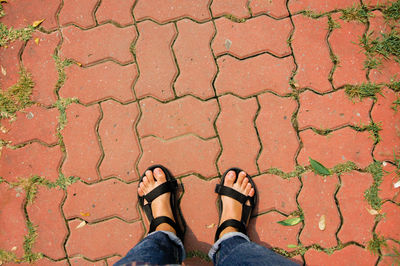 Low section of person standing on footpath