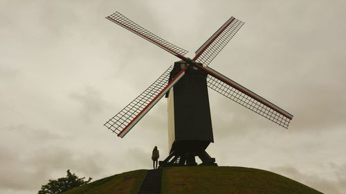 Low angle view of traditional windmill against sky