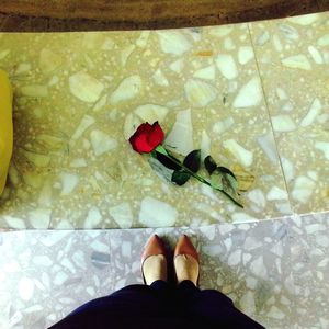 Low section of woman standing on tiled floor