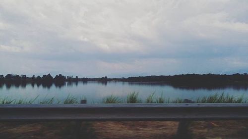 Scenic view of lake against cloudy sky