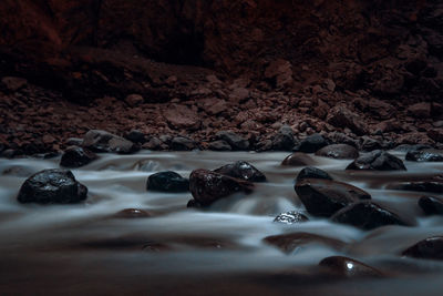 Close-up of wet rocks on shore