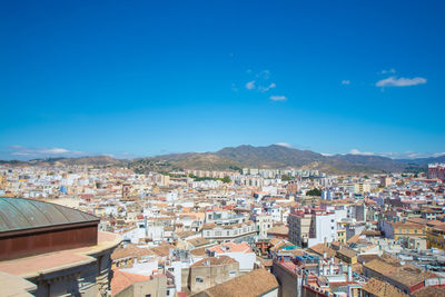 High angle view of townscape against blue sky