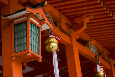 Low angle view of lantern hanging on ceiling of building