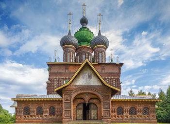 Low angle view of temple building against cloudy sky