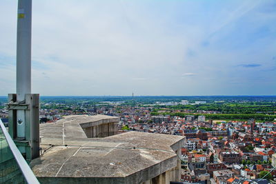 Aerial view of townscape by sea against sky
