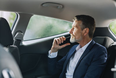 Businessman sitting in car