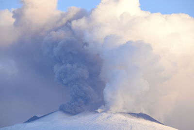 Scenic view of volcanic mountain against sky etna eruption