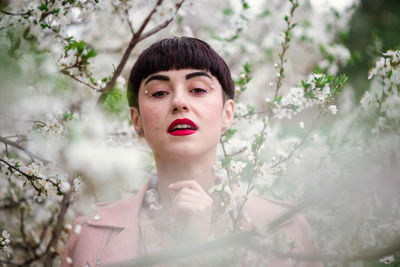 Portrait of beautiful woman against plants