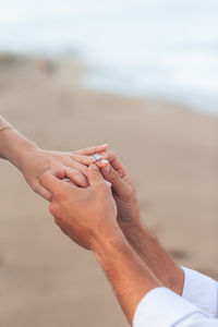 Cropped hand of person at beach