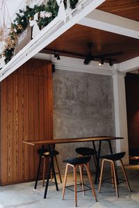 Empty chairs and table in building