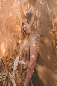 Portrait of woman with plants in field