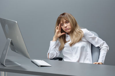 Portrait of young woman using laptop at home