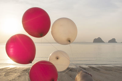 Close-up of balloons on beach