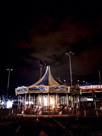 Illuminated bridge against sky at night