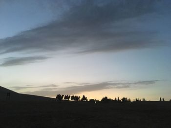 Silhouette landscape against sky during sunset