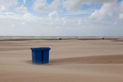 Lifeguard hut on beach against sky