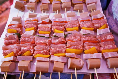 Raw meat and vegetables on skewers, ready for grilling