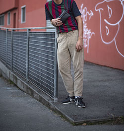 Low section of man standing on wall